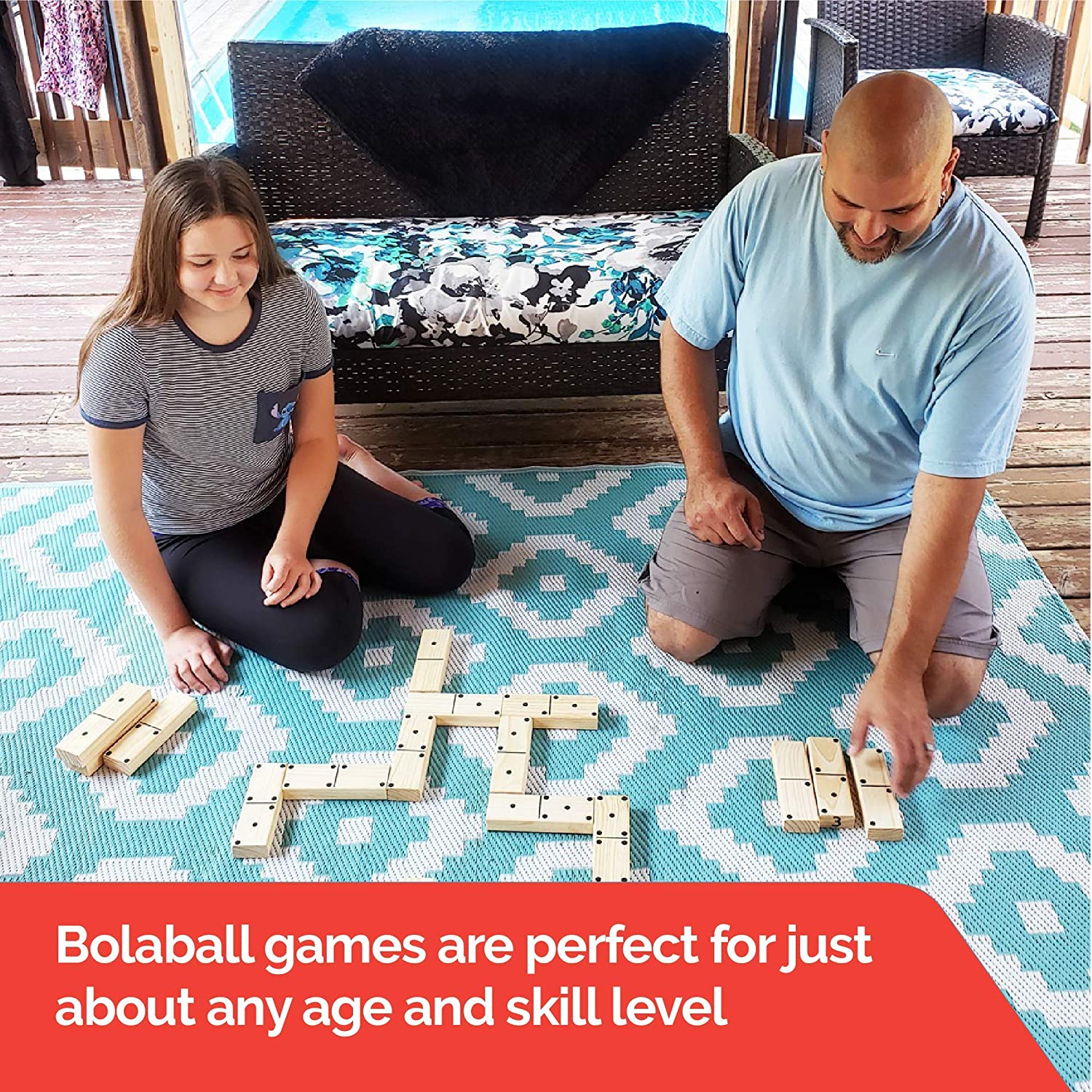 Large wooden tumbling blocks stacked in a tower, giant Jenga-style game made from smooth natural wood for family and party play